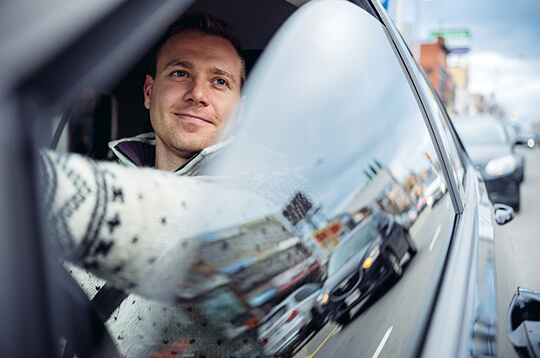 man driving with windown down